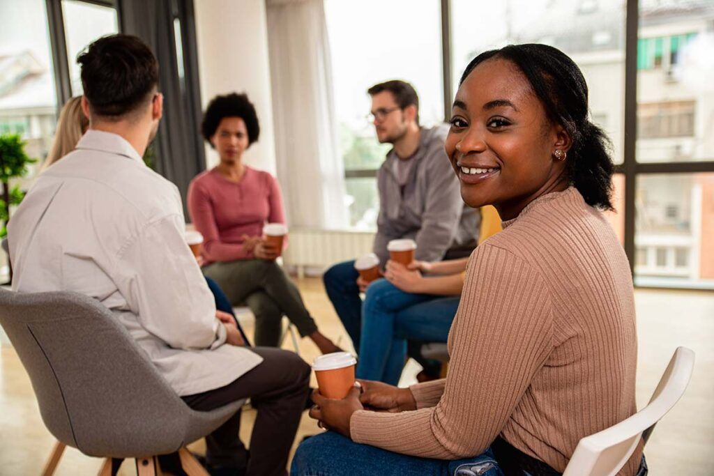 woman facilitates a group therapy session